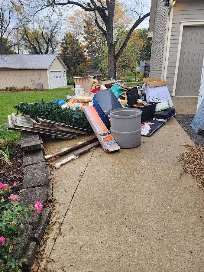 Dumpster being loaded with debris for Estate Cleanout Dumpster Rental in On Top of the World
